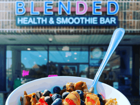 Blended Health and Smoothie Bar sign and a smoothie bowl.