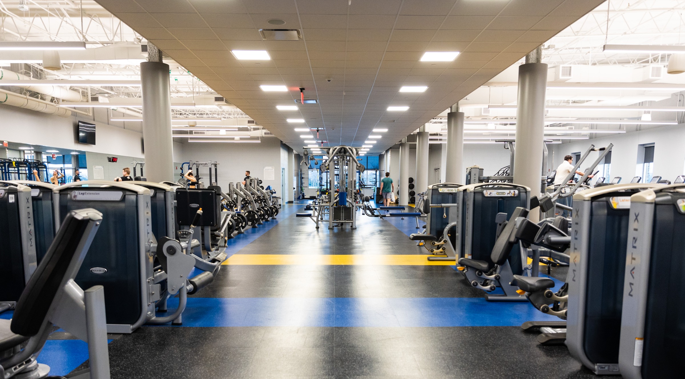 Rows of exercise machines with weight machines in the center