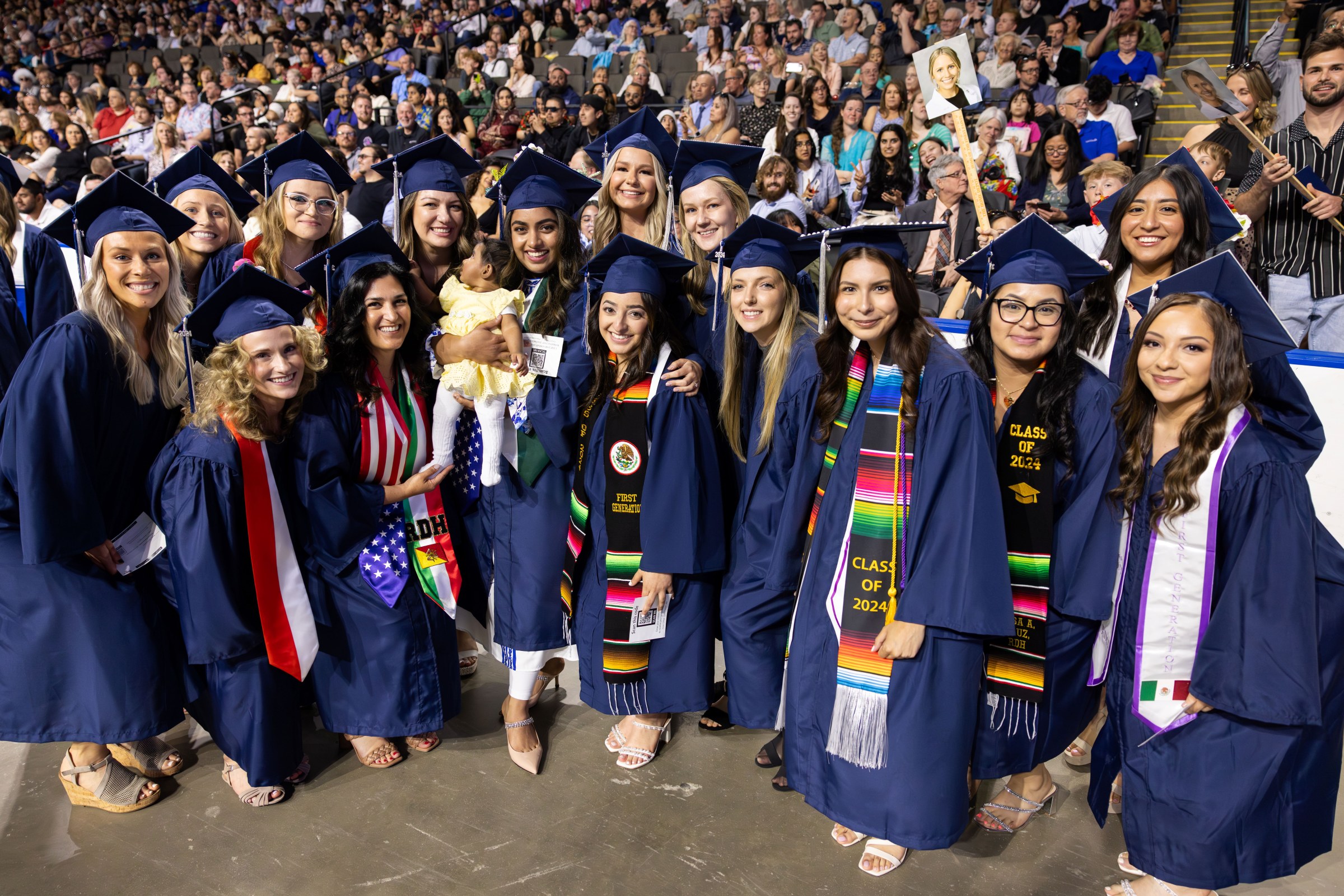 A group of Harper graduates and a baby