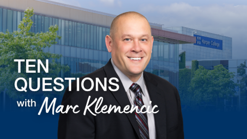 Mark Klemencic stands behind text that says Ten Questions With Mark Klemencic