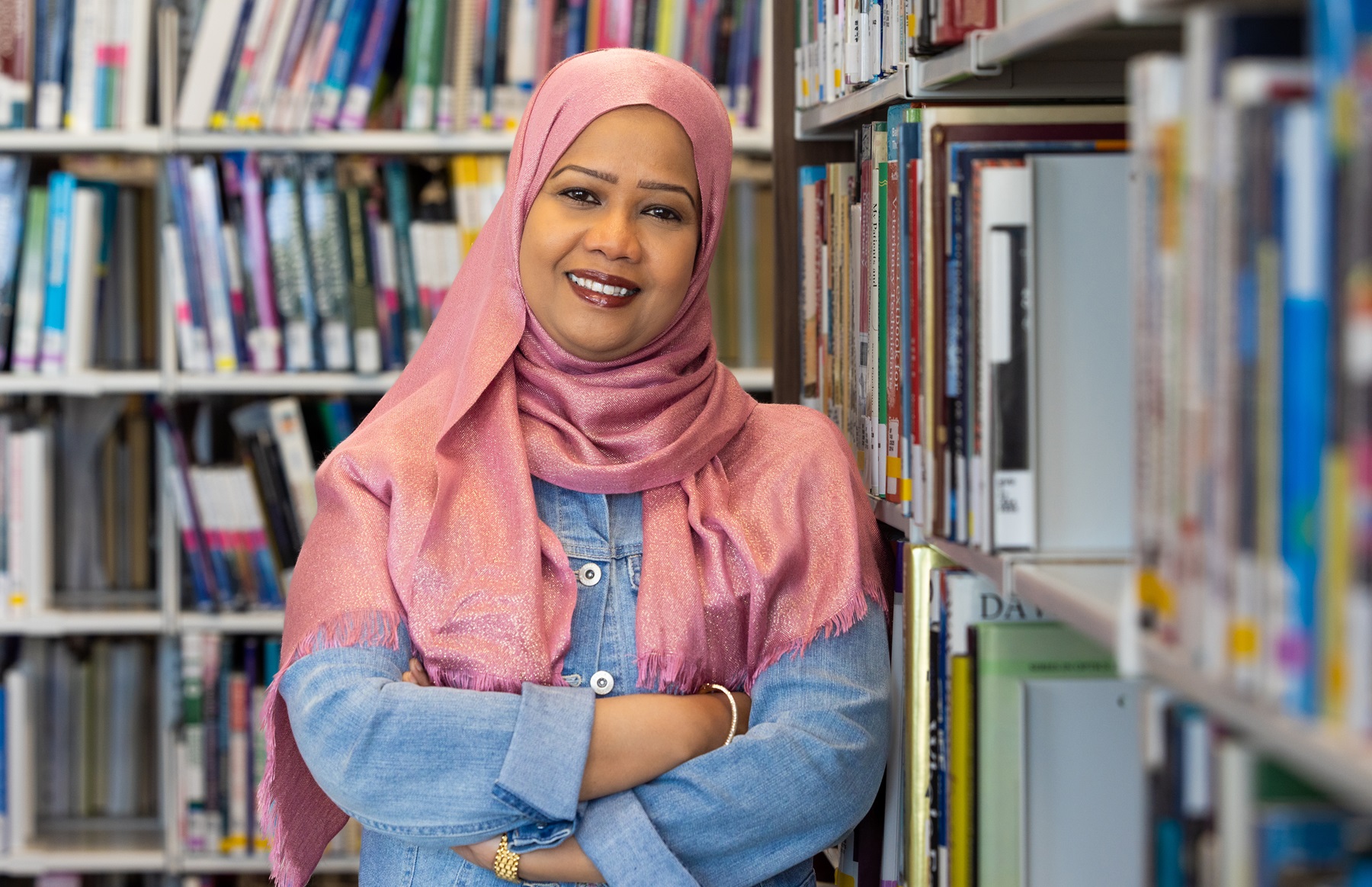 Asfa Alamelhuda poses in the library at Harper College.