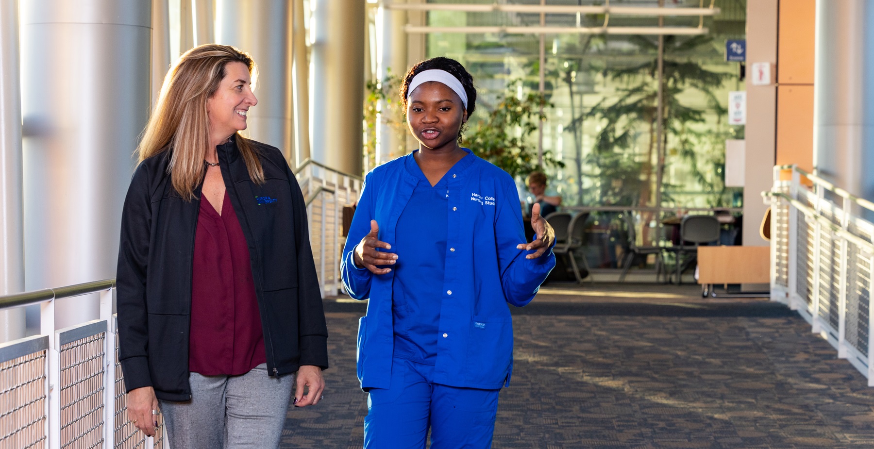 Chris Pykett and Sonia Ajakaiye walk and talk in Harper College's Avante Center.