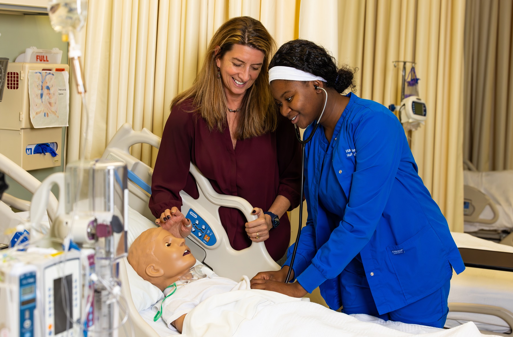 Chris Pykett and Sonia Ajakaiye interact in a Harper College simulation lab.