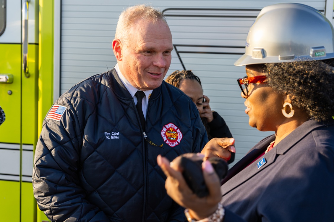 Elk Grove Village Fire Chief Richard Mikel speaks with Harper College President Avis Proctor during the groundbreaking ceremony for Harper's Emergency Services Training Center.