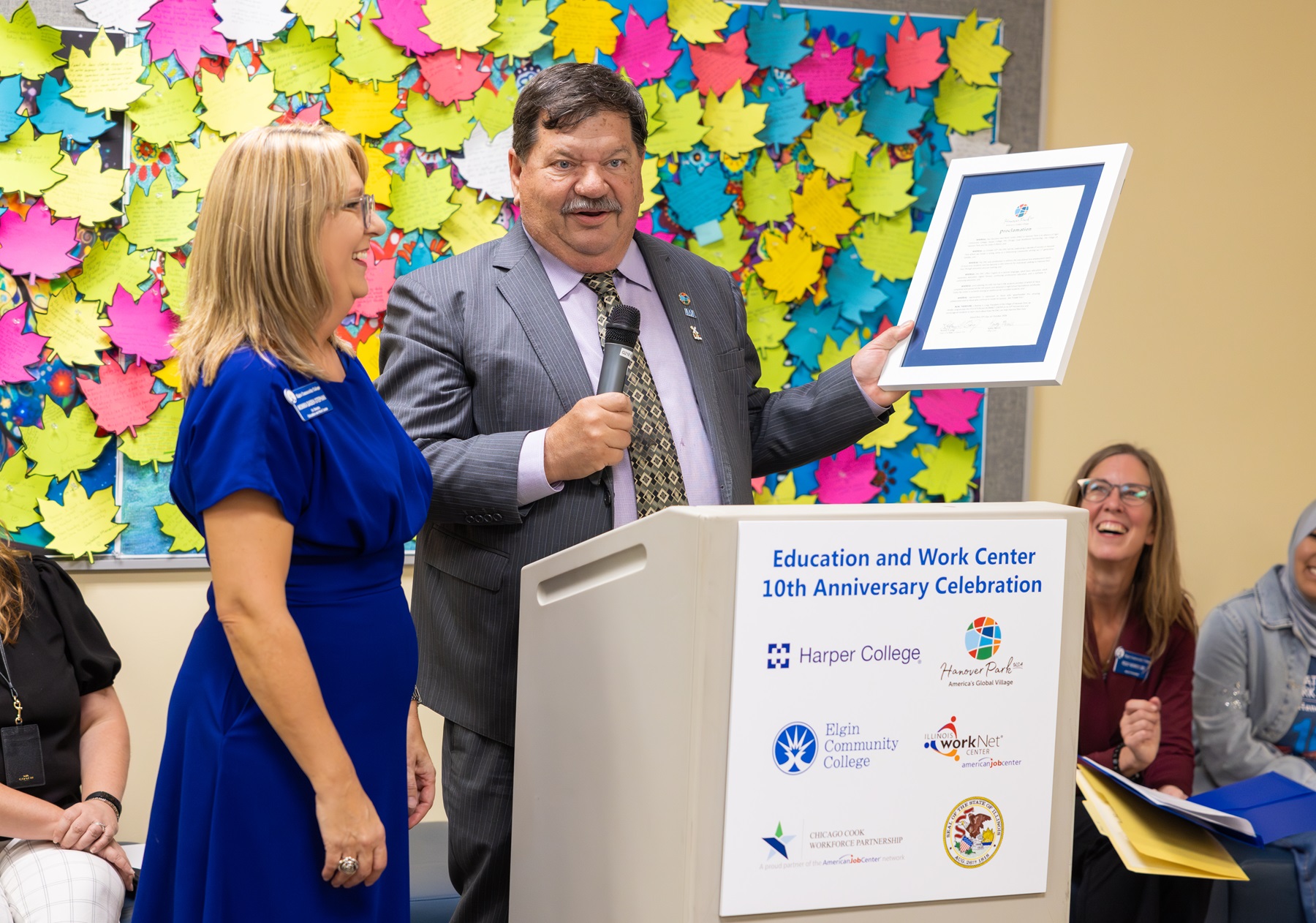 Hanover Park Mayor Rod Craig presents EWC Senior Director Monika Gadek-Stephan with a proclamation for EWC's 10th anniversary.