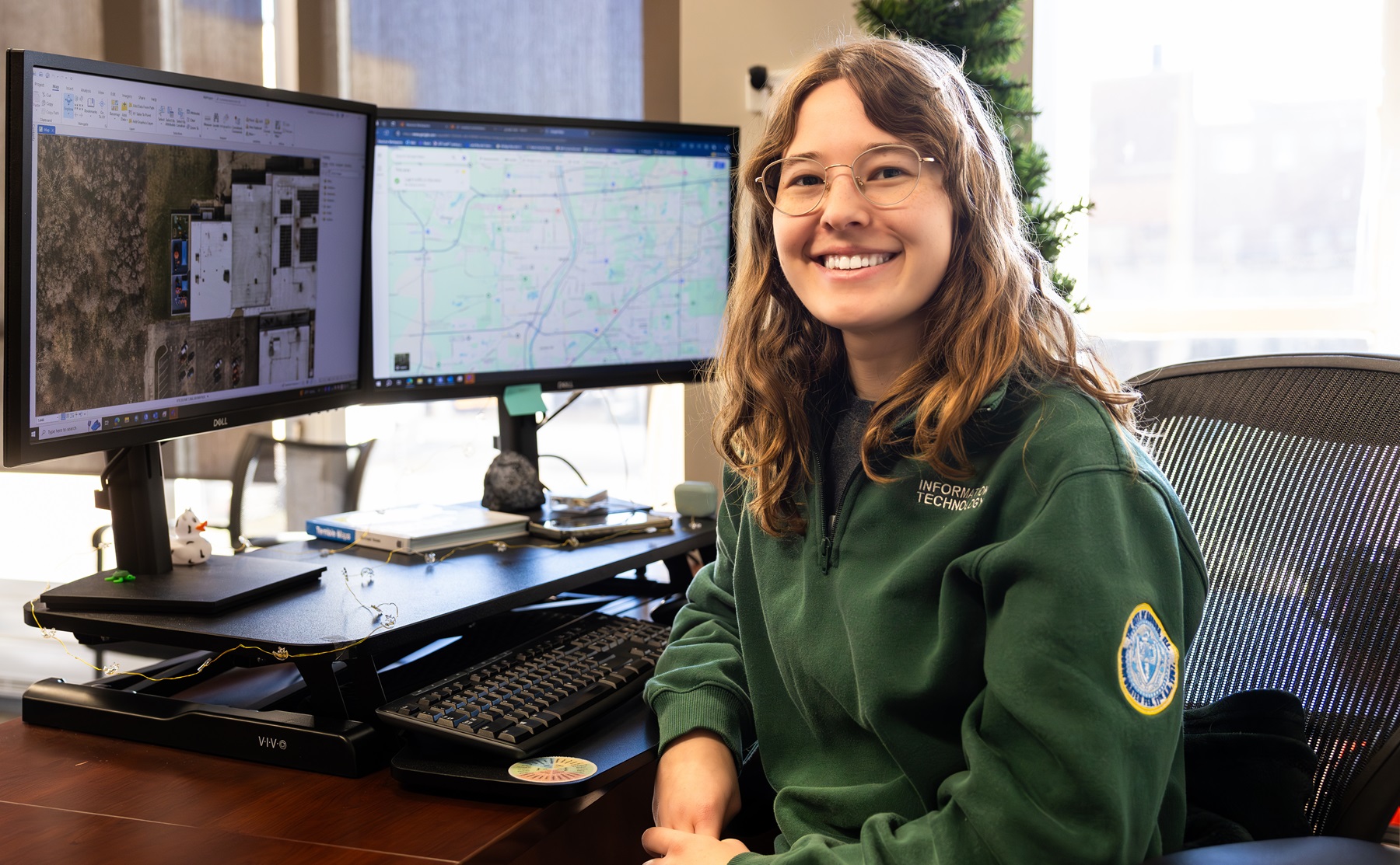 Carolina Szoepe sits at her workstation at the city of Aurora's IT department