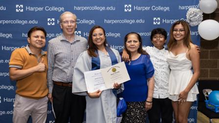 Gricelda Adame-Garcia celebrates with her family at Harper College's Illinois High School Diploma Ceremony.