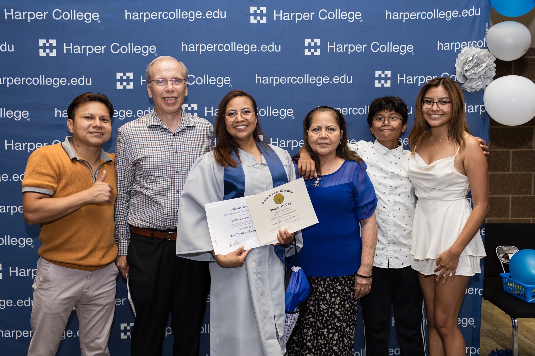 Gricelda Adame-Garcia celebrates with her family after receiving her Illinois High School Diploma at Harper College.