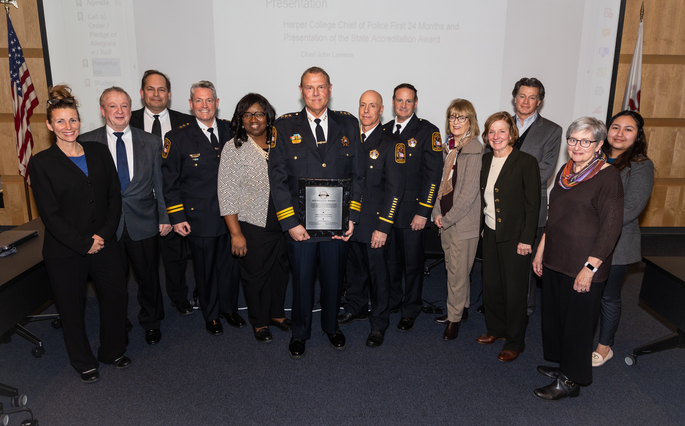 Harper College leaders pose with the accreditation plaque