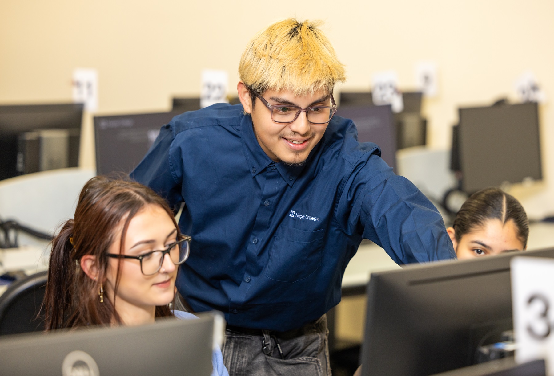 Javi Rivera helps Harper College students in the Testing Center.