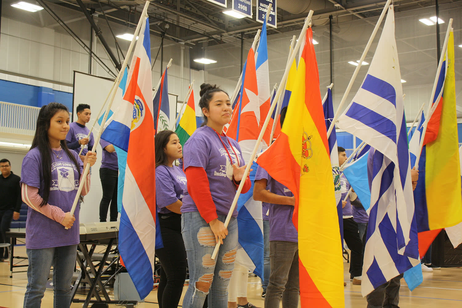 Students carry flags during 19th annual Latino Summit's flag ceremony