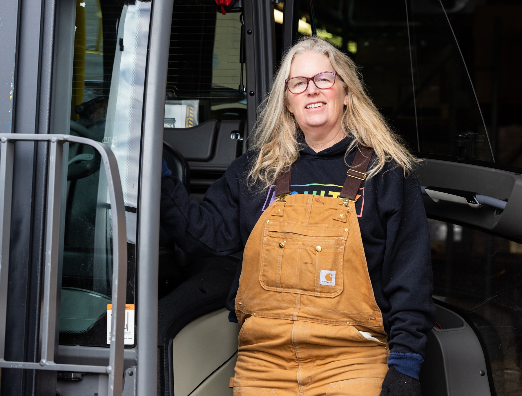 Michelle Mabry stands next to a forklift on Harper's campus