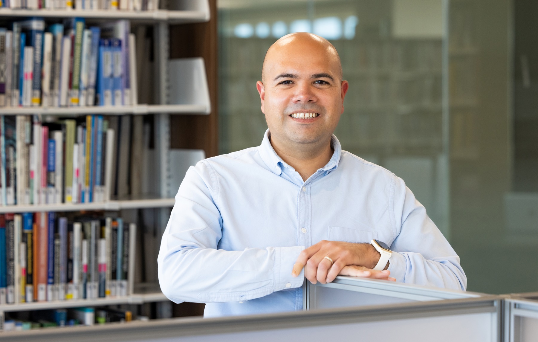 Omar Sánchez poses in Harper College's library.