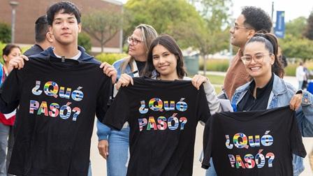 Students holding PASO shirts at Harper Fiesta