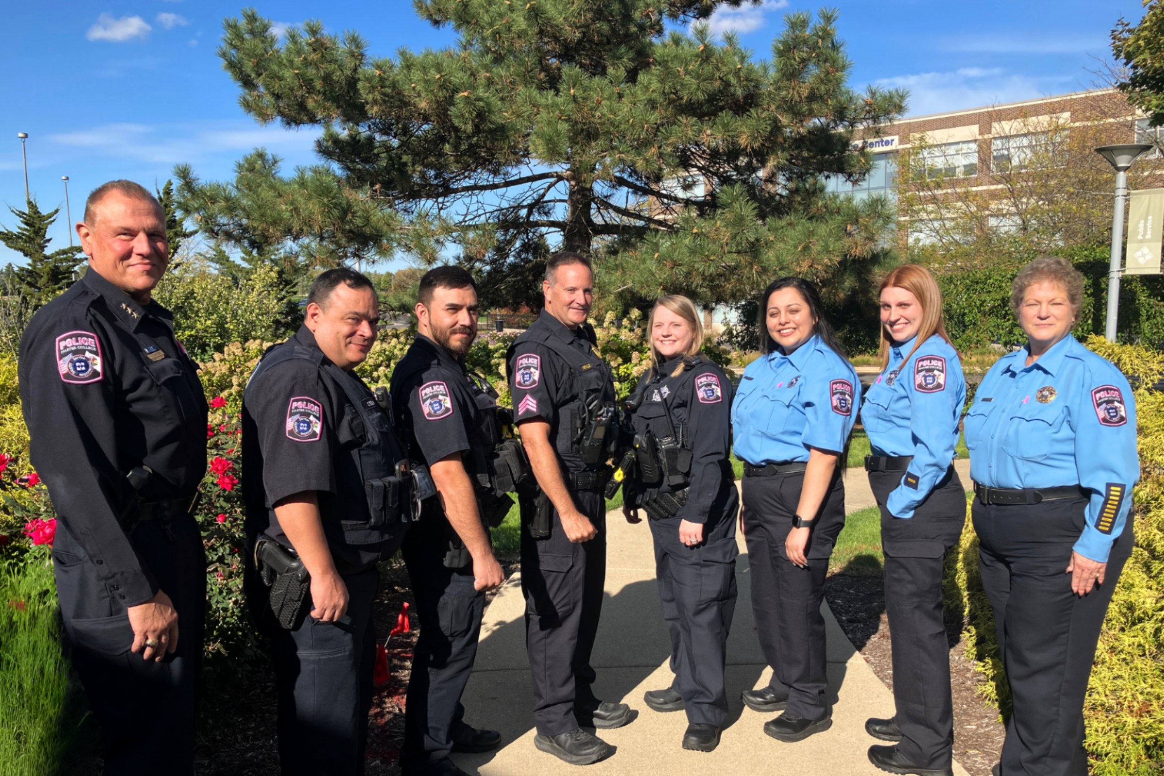 Several members of the Harper College Police Department display their pink patches.