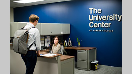 A University Center employee welcomes a student