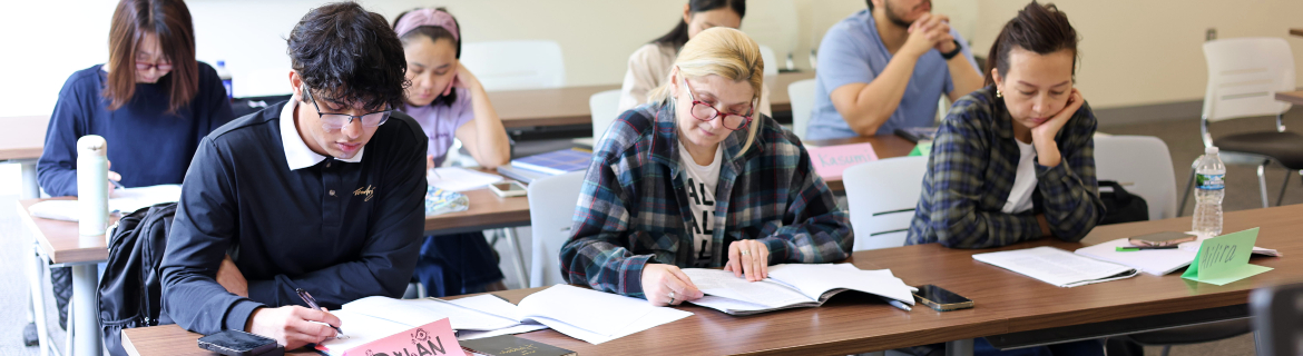 Harper College AED High School Equivalency Classroom Students in Harper College's High School Equivalency program work on analyzing a book in their English class on campus in Palatine, Illinois.
