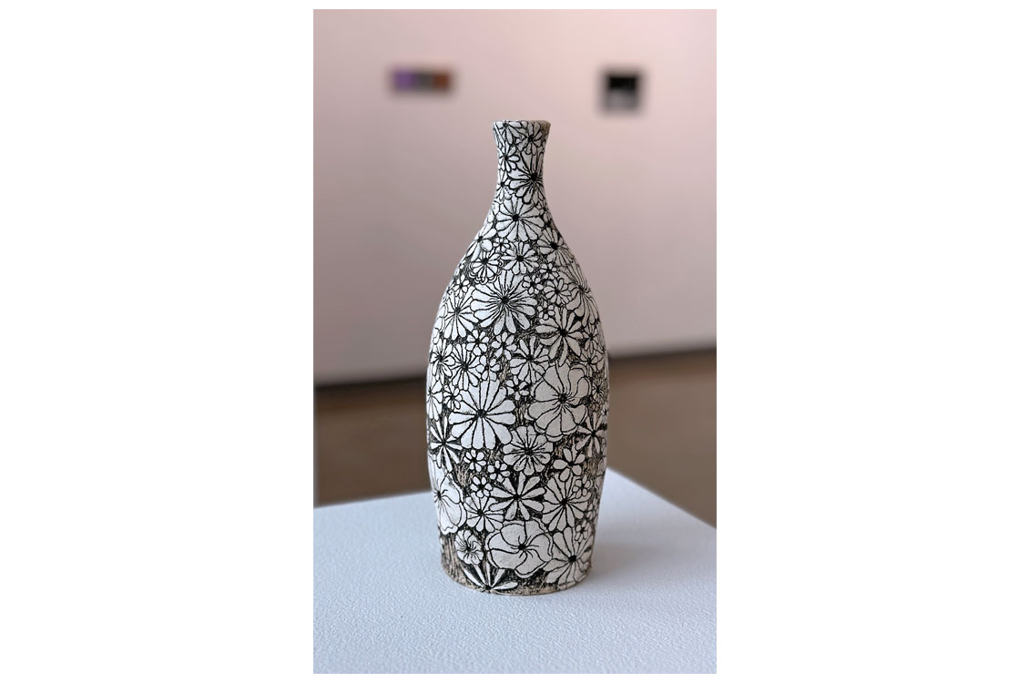 a ceramic vase with a flower motif