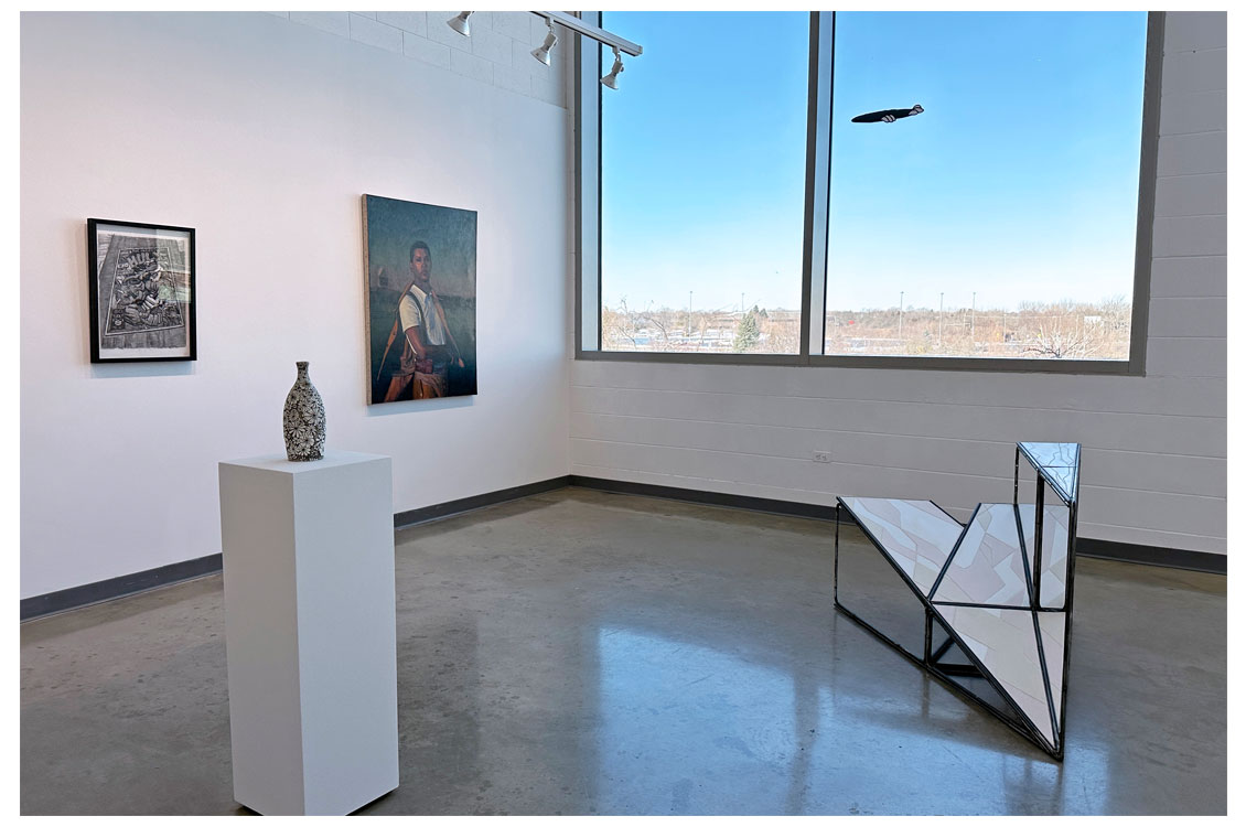 interior gallery view of paintings hung near window