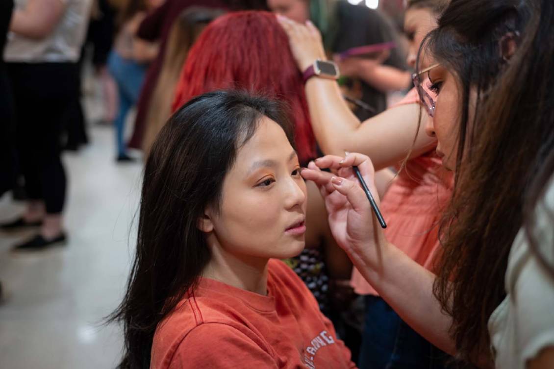 Make-up artist doing make-up for one of the models