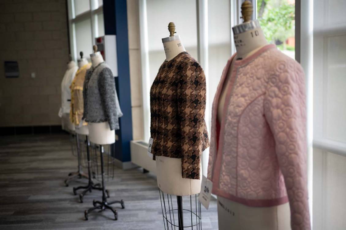 Row of clothes set up on mannequin stands