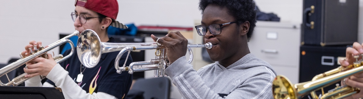 Trumpet players in the Harper Wind Symphony practice in the music rehearsal space on Harper College's campus in the Chicago suburbs.