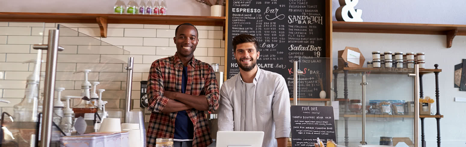 Two business partners standing in their cafe photo.