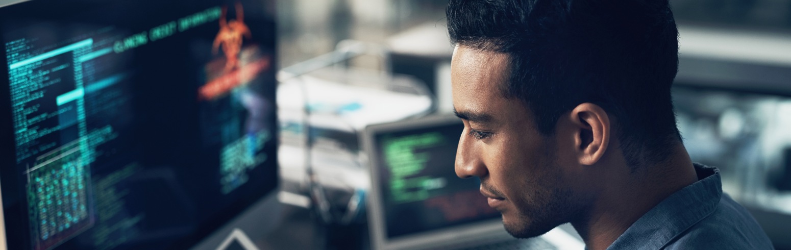 Man typing code at a computer