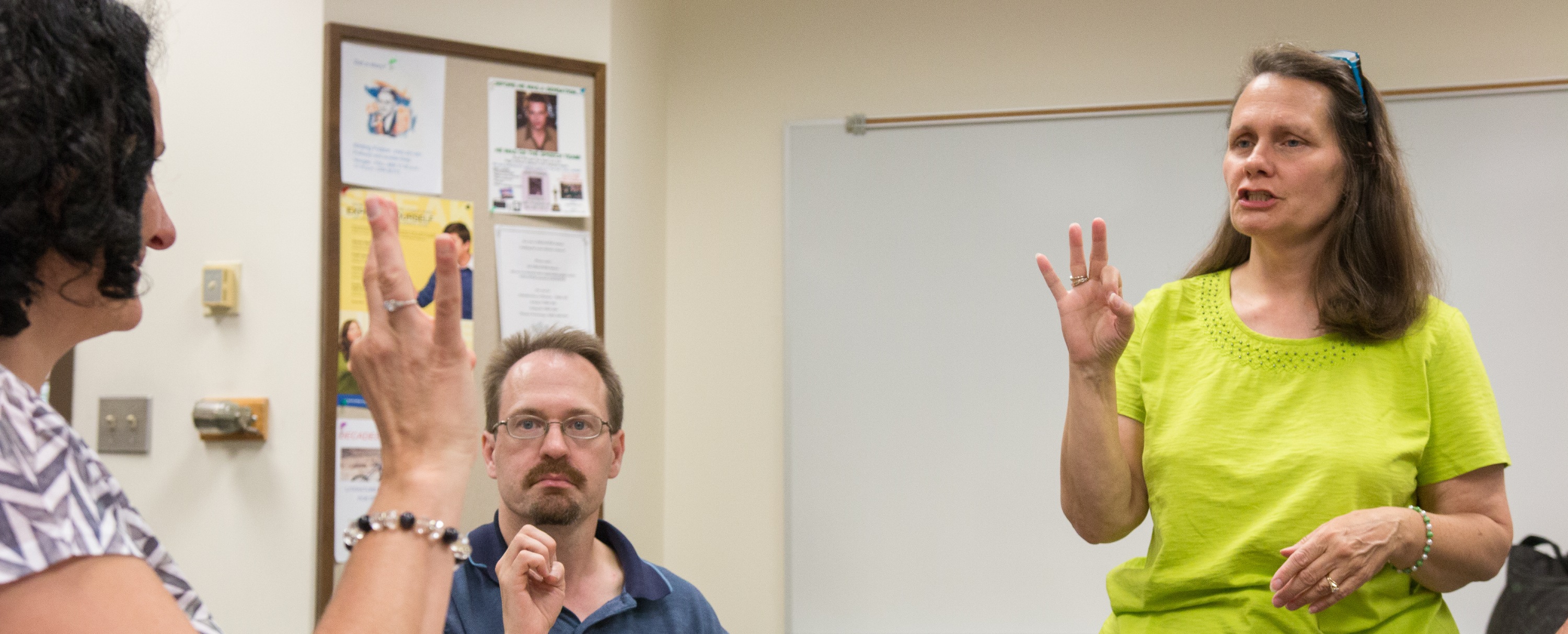 ASL instructor leading a sign language course for beginners.