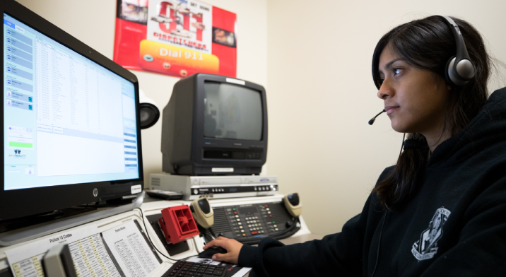 A student works in the on-site lab to practice skills as an emergency services dispatcher.