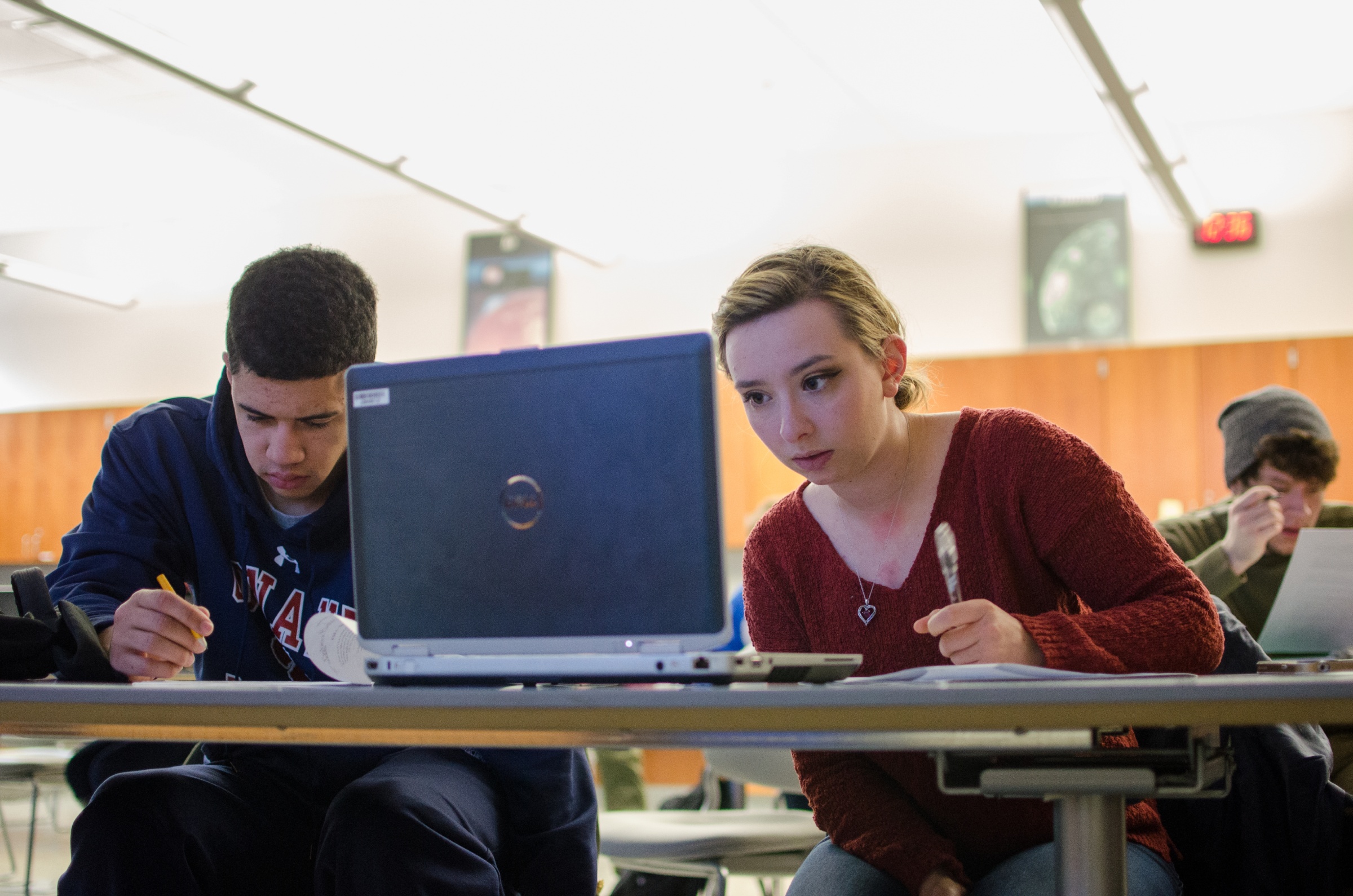 Two Harper CPE students work on an assignment with their laptops in a classroom on campus in the Chicago suburbs.