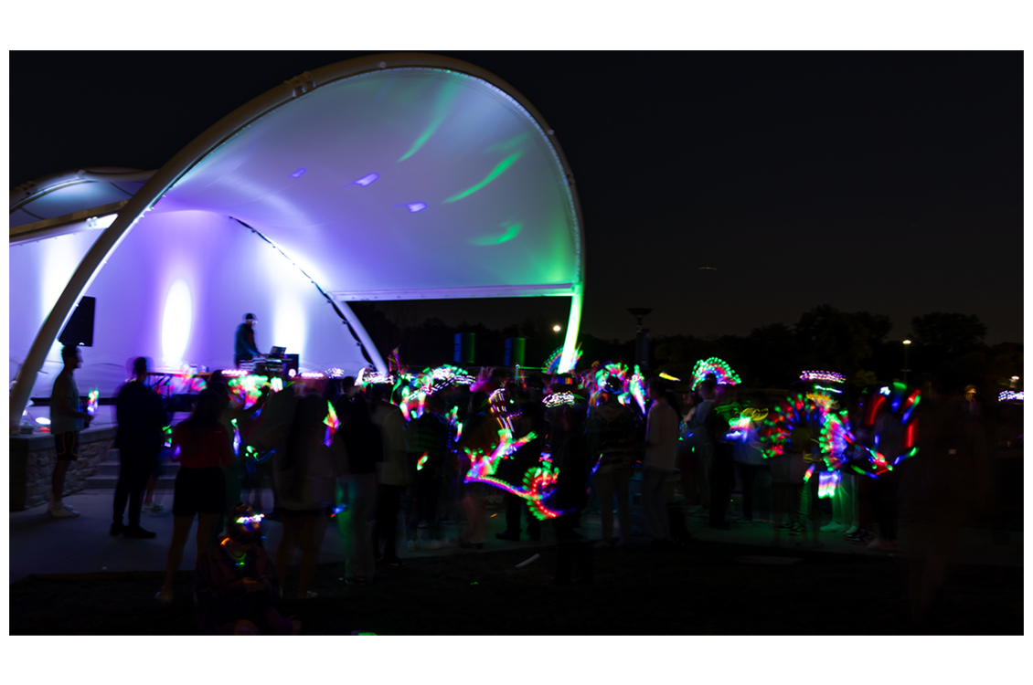 a night show with audience members waving glowsticks