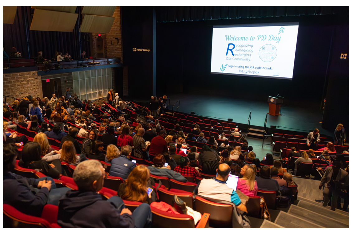 people attending a lecture in a theater