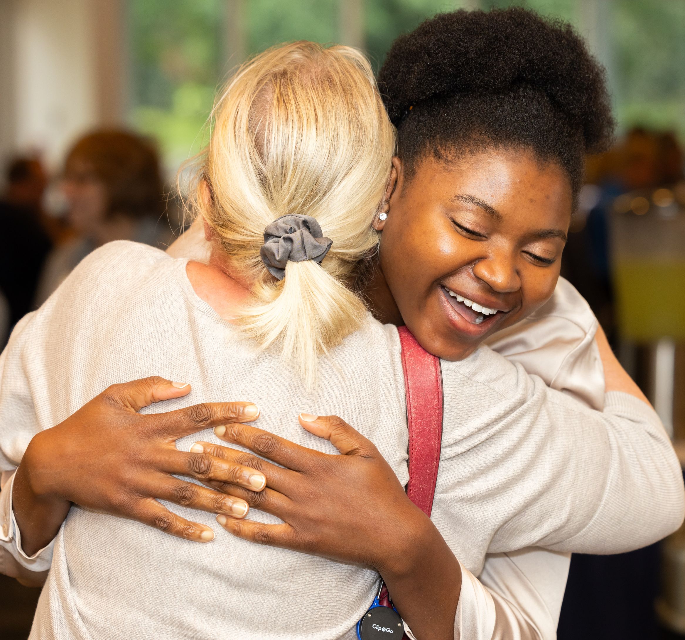 HOPE Giving circle student and member Scholarship recipient hugging a HOPE member