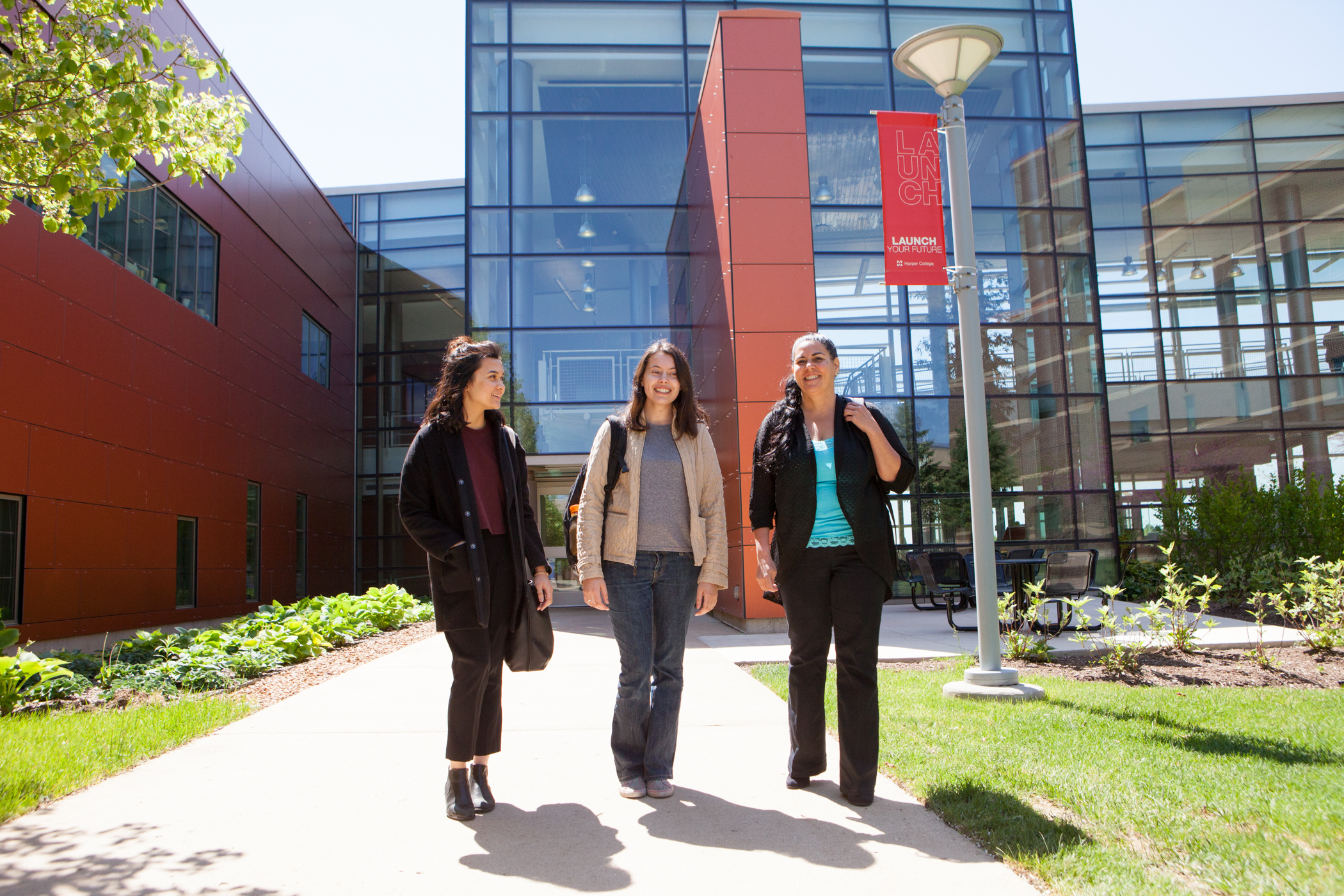 four students holding up a pathways check for 10,000 dollars