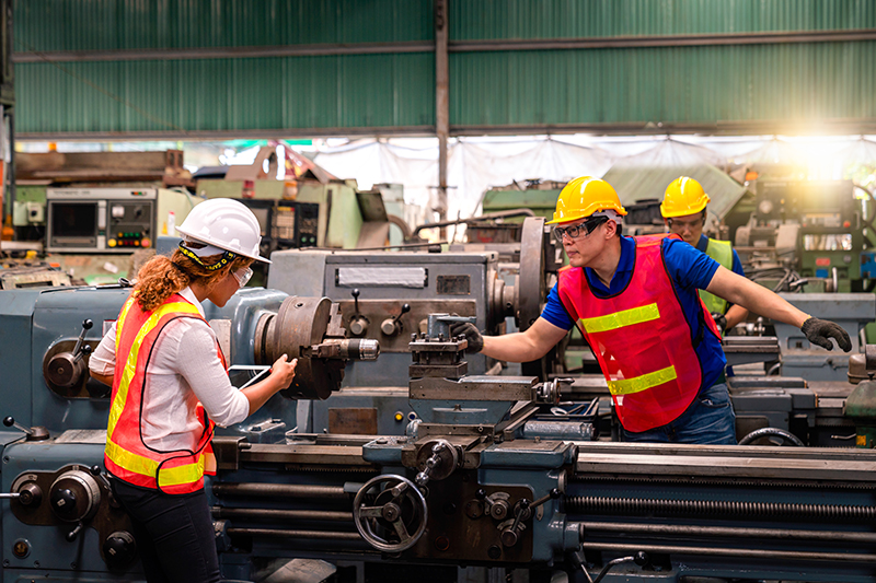 Construction workers operating machinery