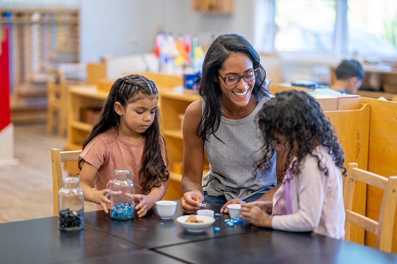 Teacher assisting children in an educational setting