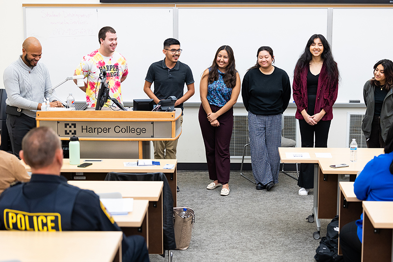 Students presenting in front of a classroom