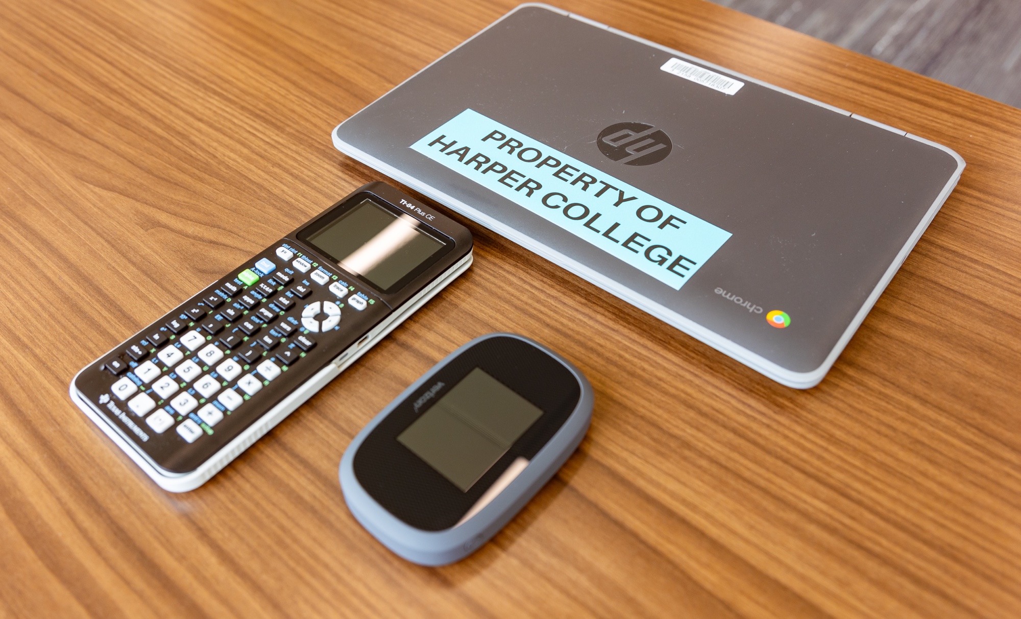 Chromebook, calculator, and hotspot on a table