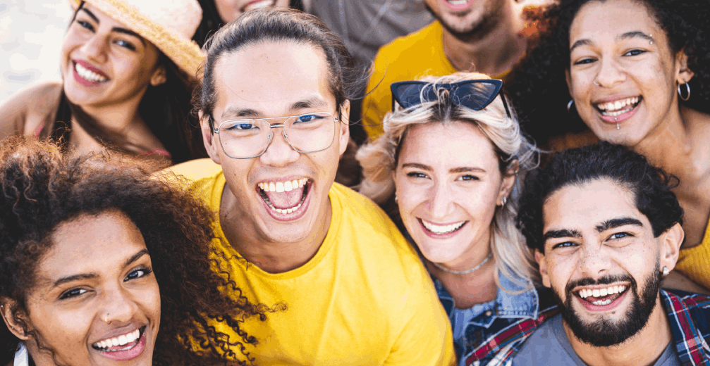 Group of diverse friends smiling and posing together.