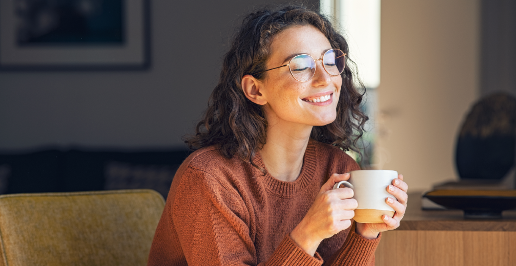 Smiling woman holding a cup of coffee.