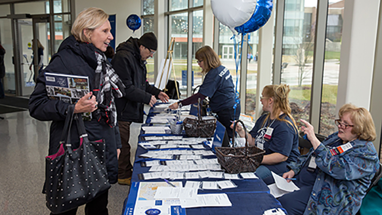 alumni talking at event