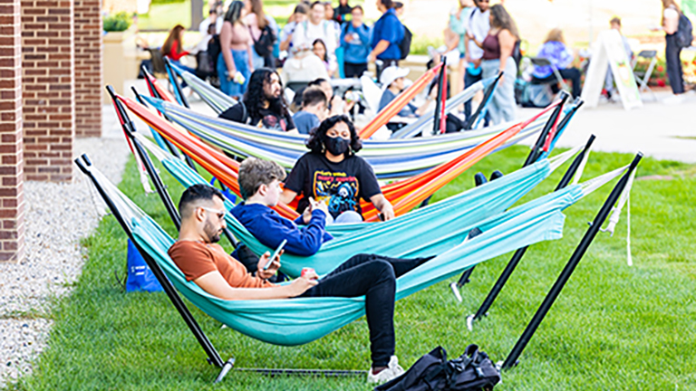 student lounging in hammock