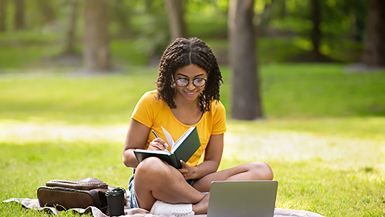 student on campus outdoor studying