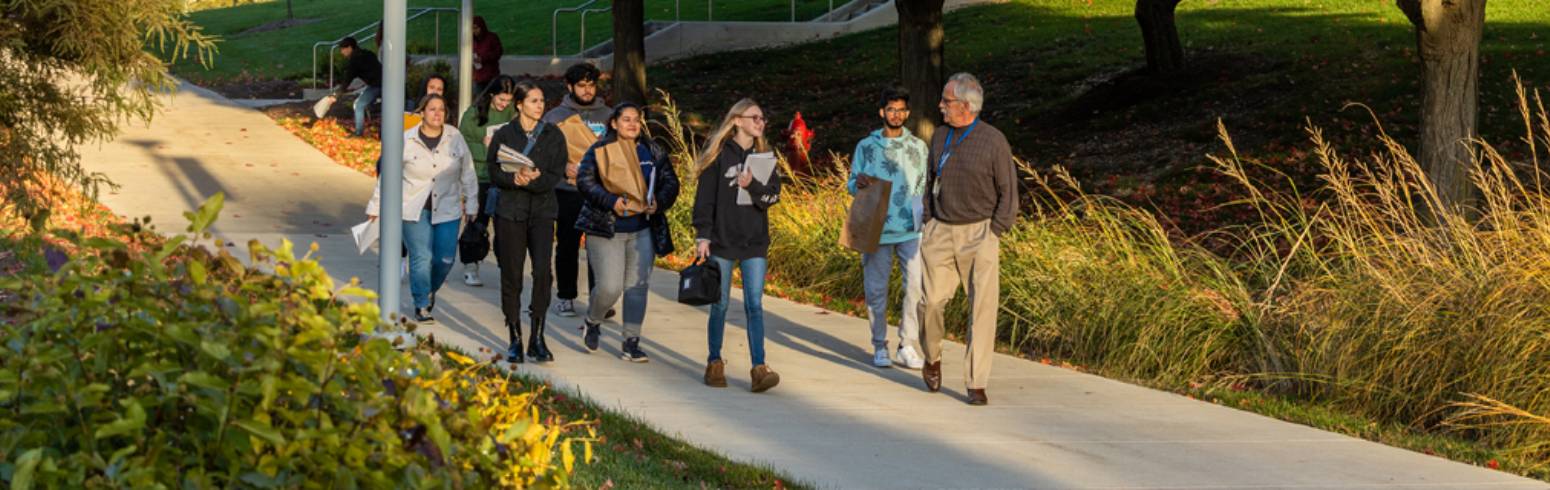 A guide leads prospective students through campus.