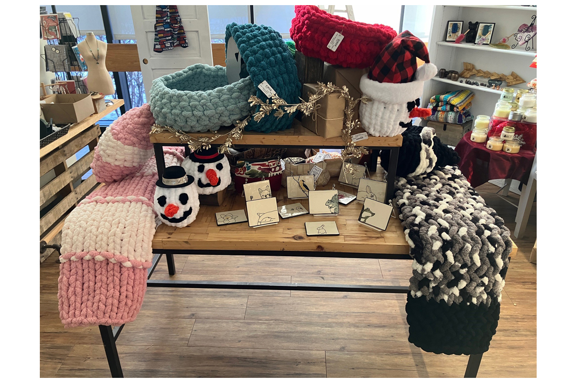 knitted blankets and jewelry on display table