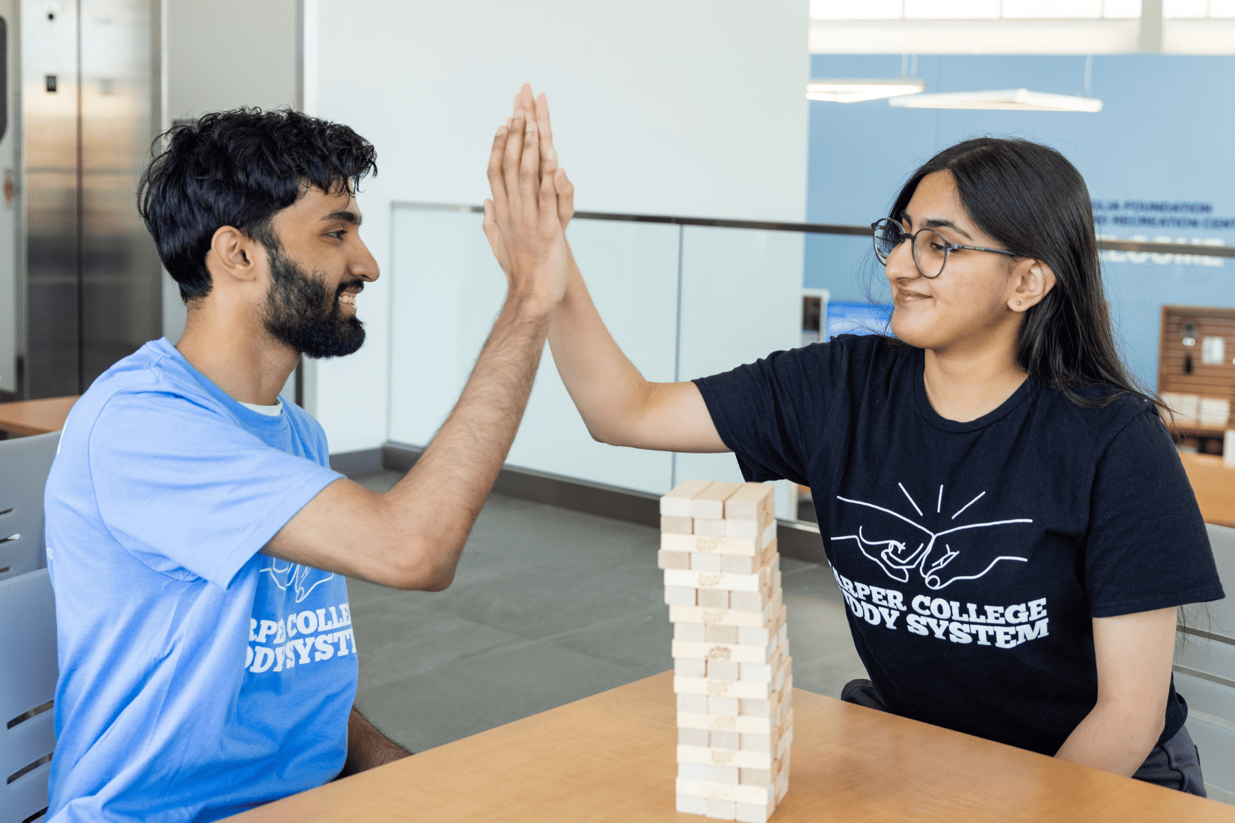 Two Student Giving a High Five